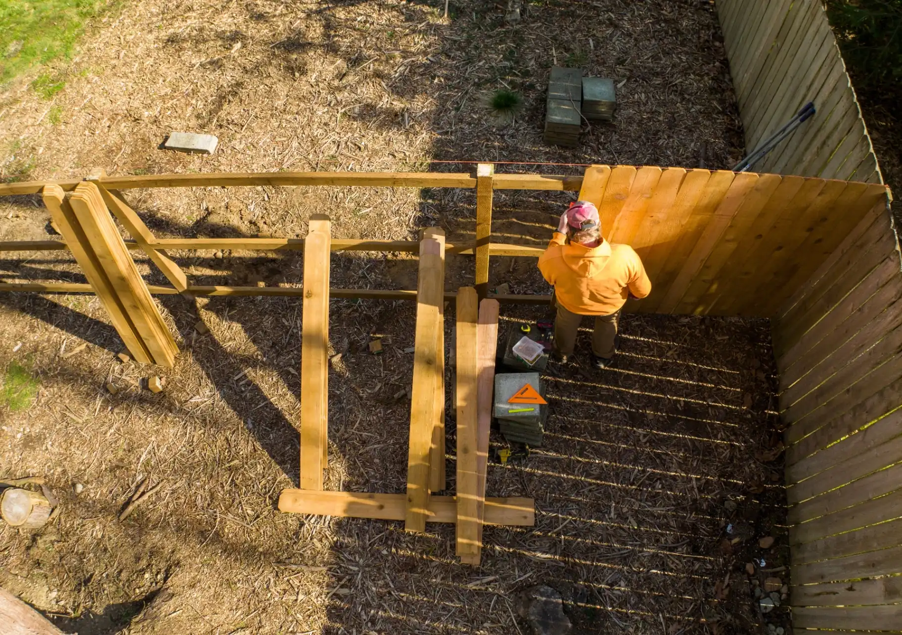 Aerial view of a licensed contractor framing a wood fence in a New Jersey backyard