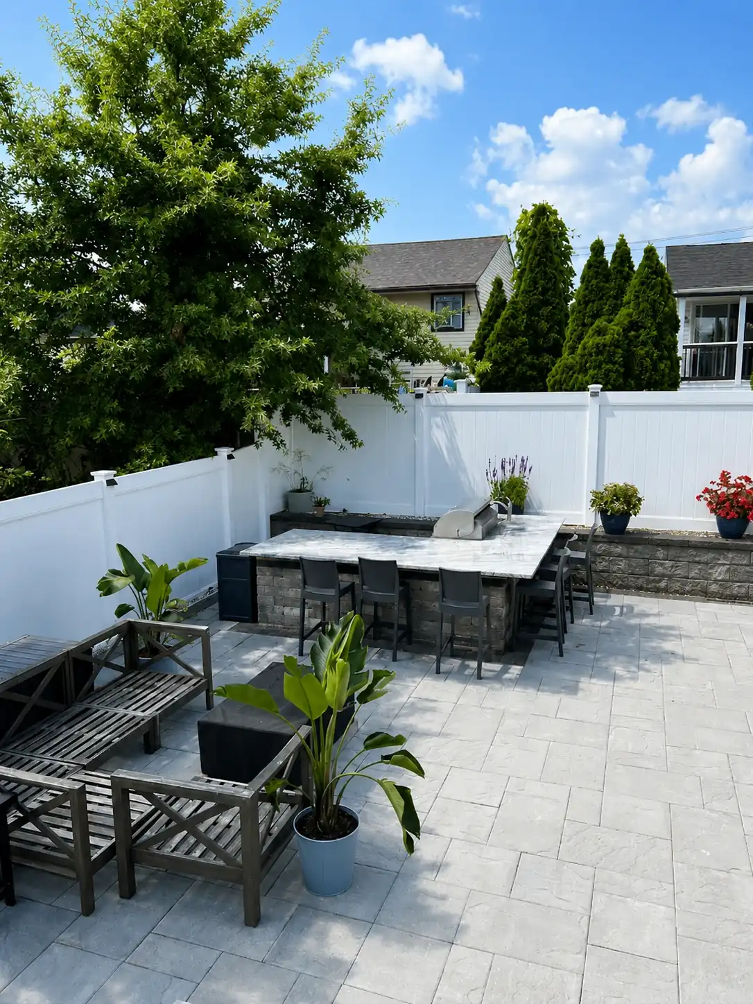 White Vinyl Privacy Fence Around Outdoor Kitchen