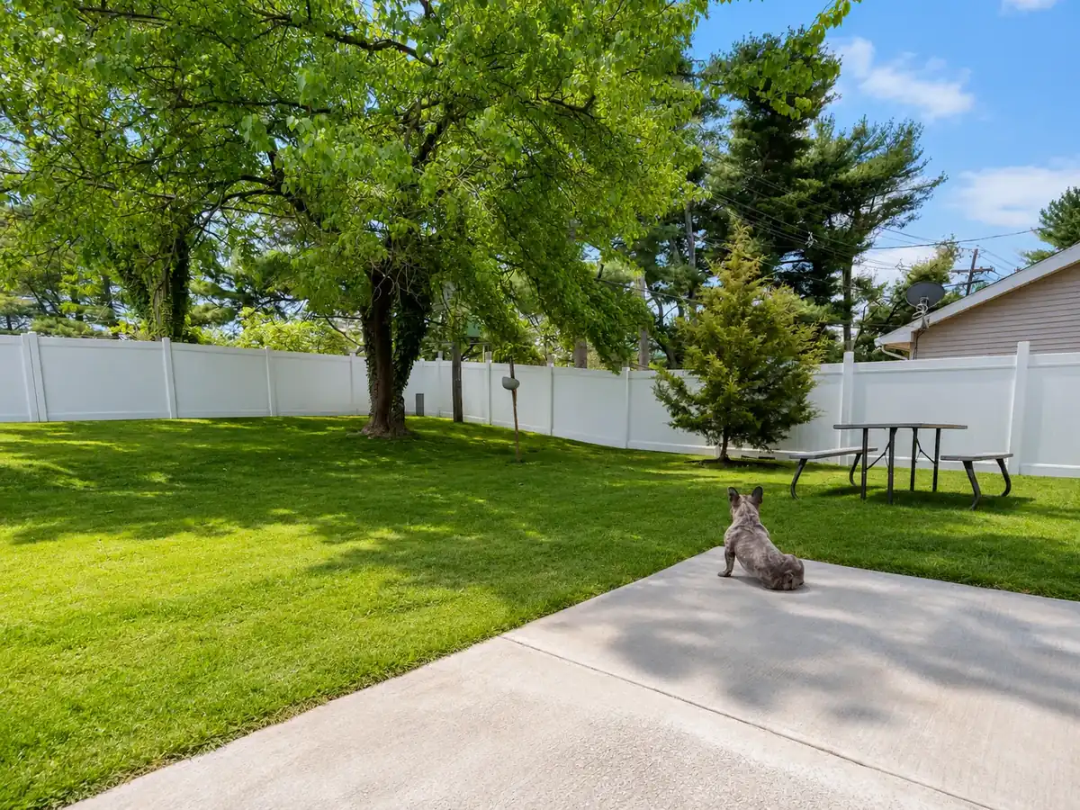 White vinyl PVC privacy fence installed in a residential backyard