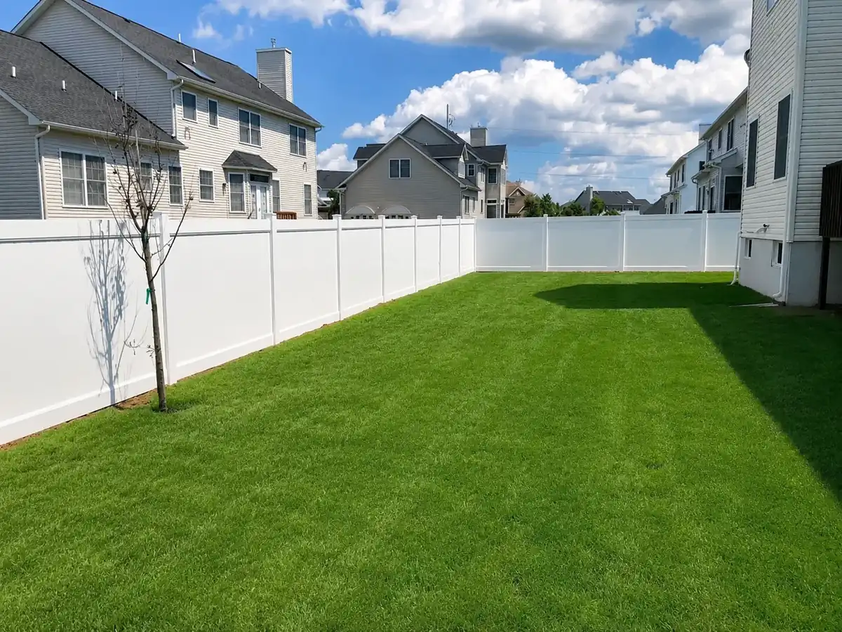 White Vinyl Privacy Fence Around Suburban Backyard