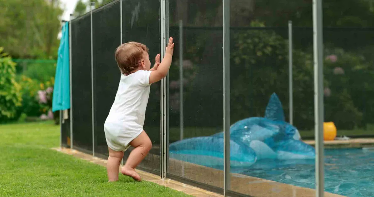 Pool mesh fence installed around backyard pool